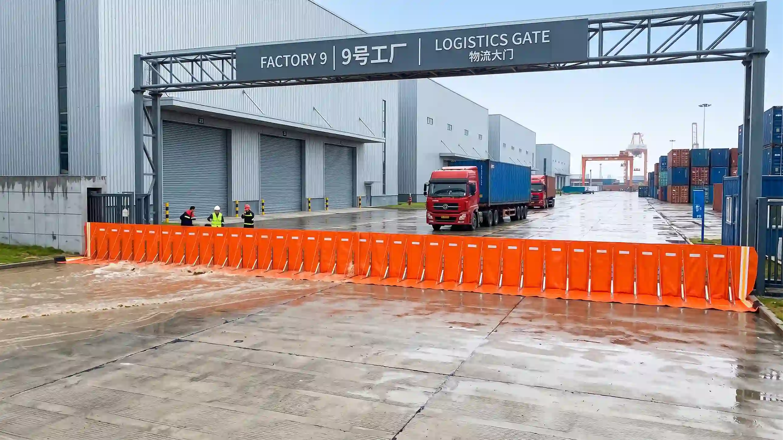Orange flood barrier protects factory logistics entrance
