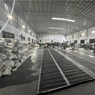 Workers produce printed waterproof sound insulation blankets