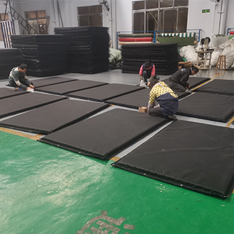 Workers produce printed waterproof sound insulation blankets