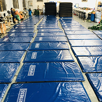 Workers produce printed waterproof sound insulation blankets